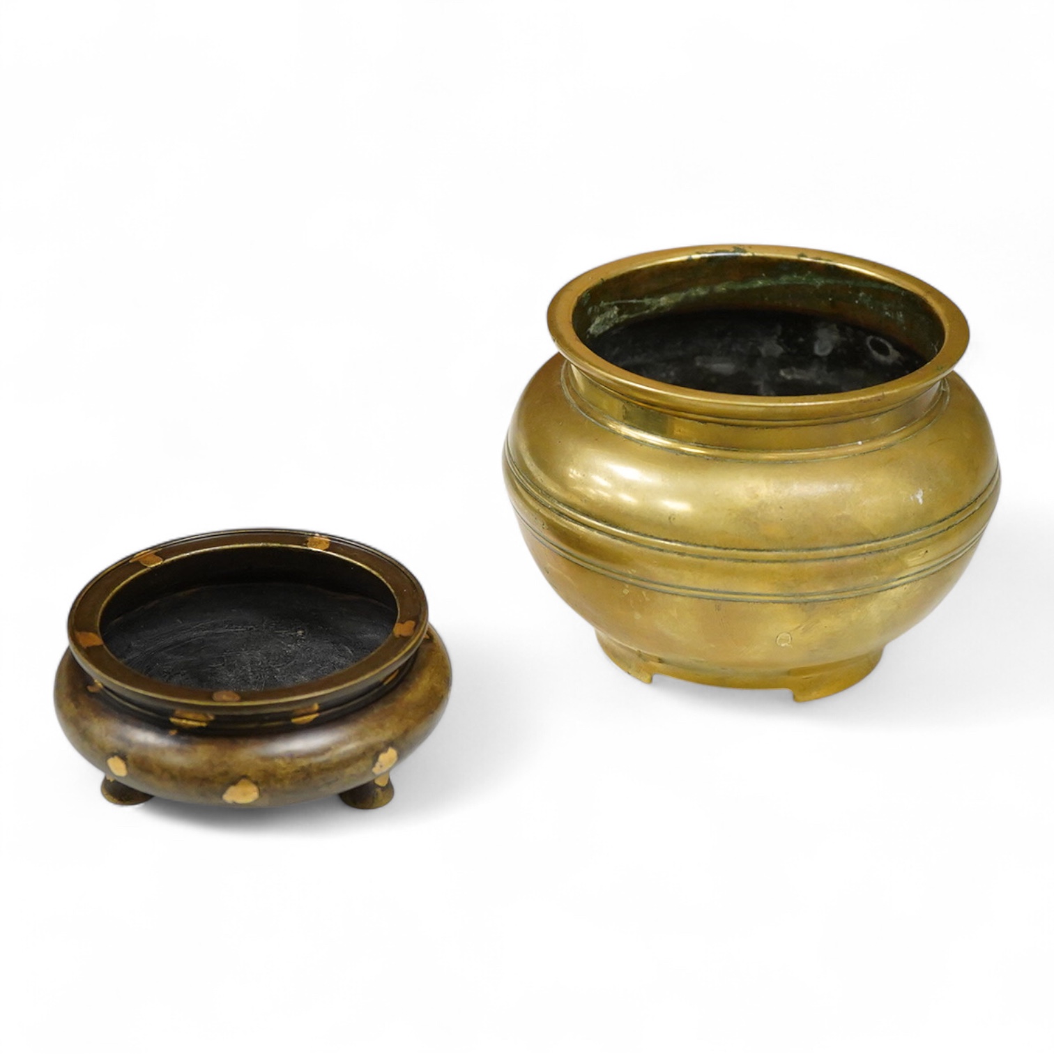 A Chinese bronze censer with gilt splashed decoration, signed with character marks to the base, together with another gilt censer, largest 12cm in diameter